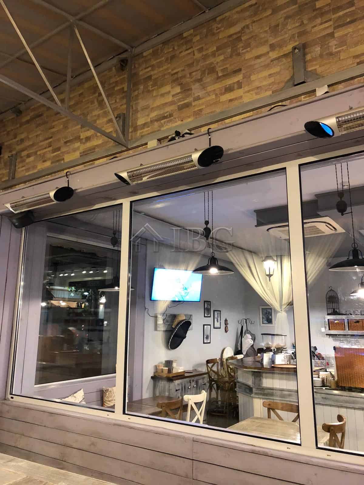 Elegant restaurant interior with large glass windows and modern decor in Nessebar.