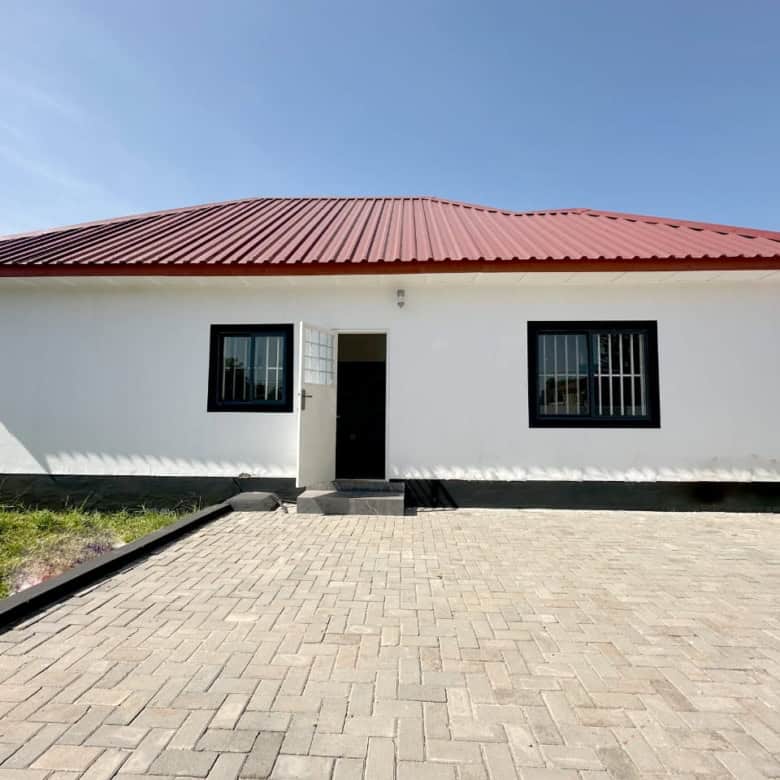 Modern 3-bed villa with white exterior and red roof in Brufut Gardens, Gambia, perfect for comfortab.