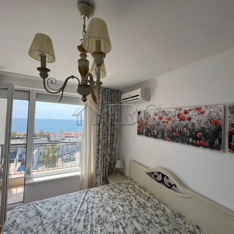 Sea view bedroom with balcony in Sveti Vlas apartment.
