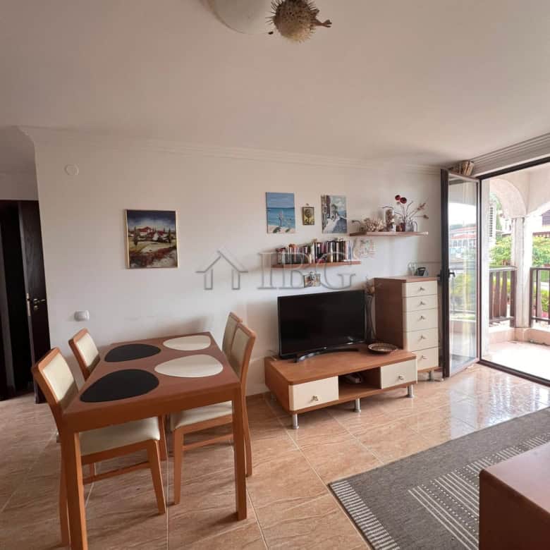 Sea and pool view apartment in Sveti Vlas, Bulgaria, with modern furnishings and balcony access.