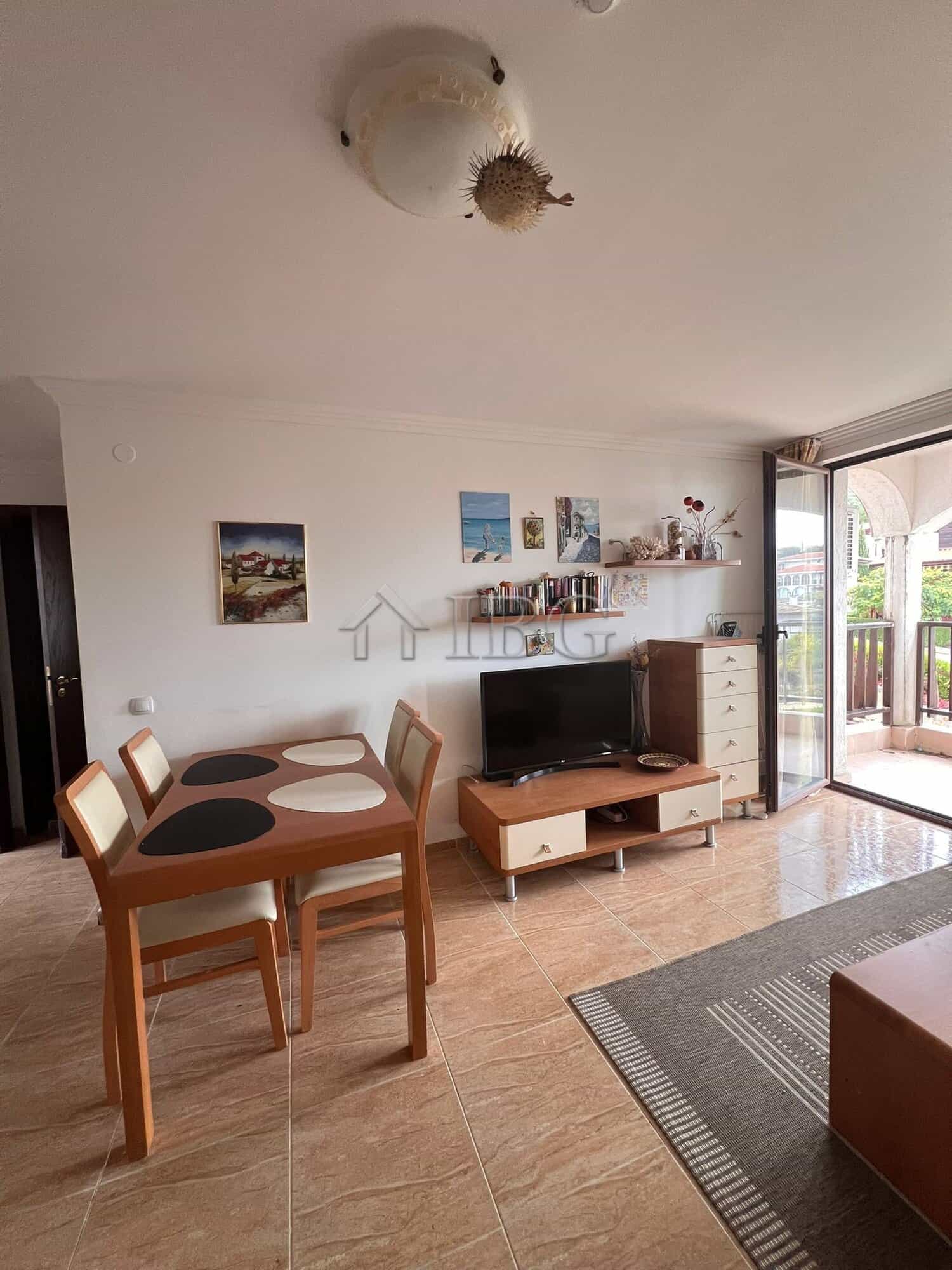 Sea and pool view apartment in Sveti Vlas, Bulgaria, with modern furnishings and balcony access.
