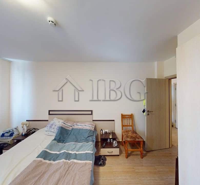 Bright bedroom with large window and pool view in Kosharitsa apartment complex.