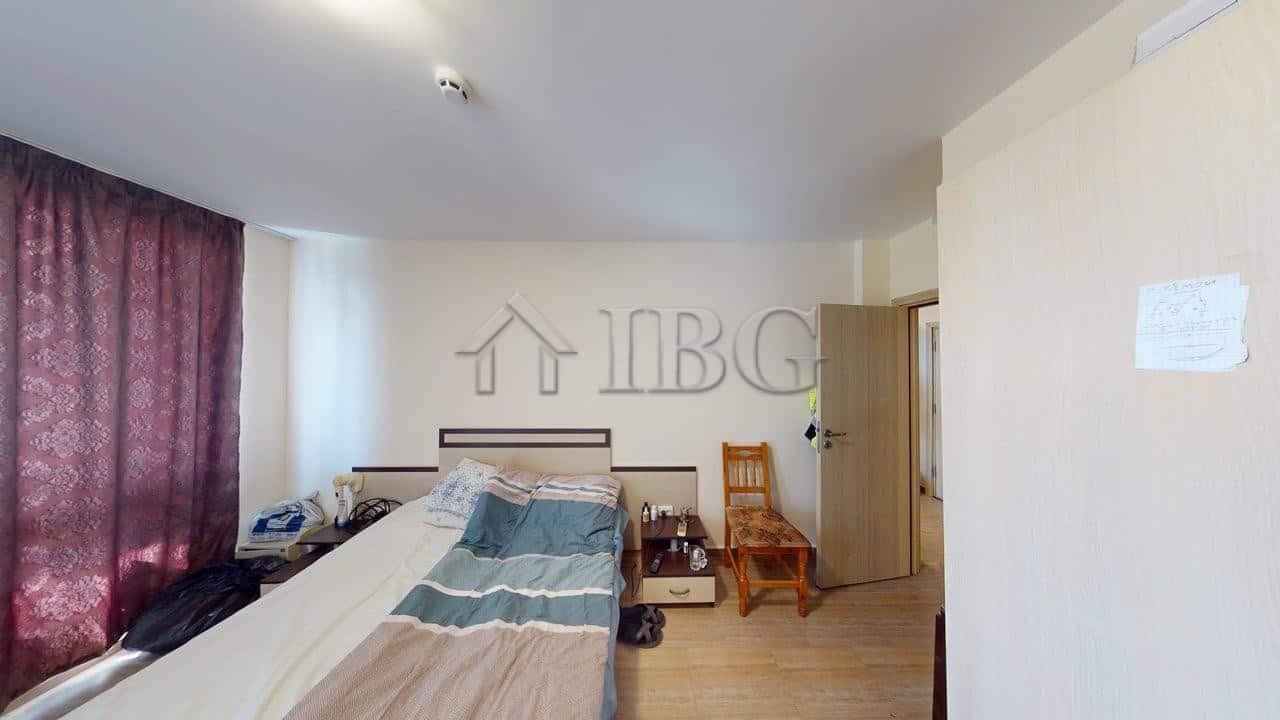 Bright bedroom with large window and pool view in Kosharitsa apartment complex.