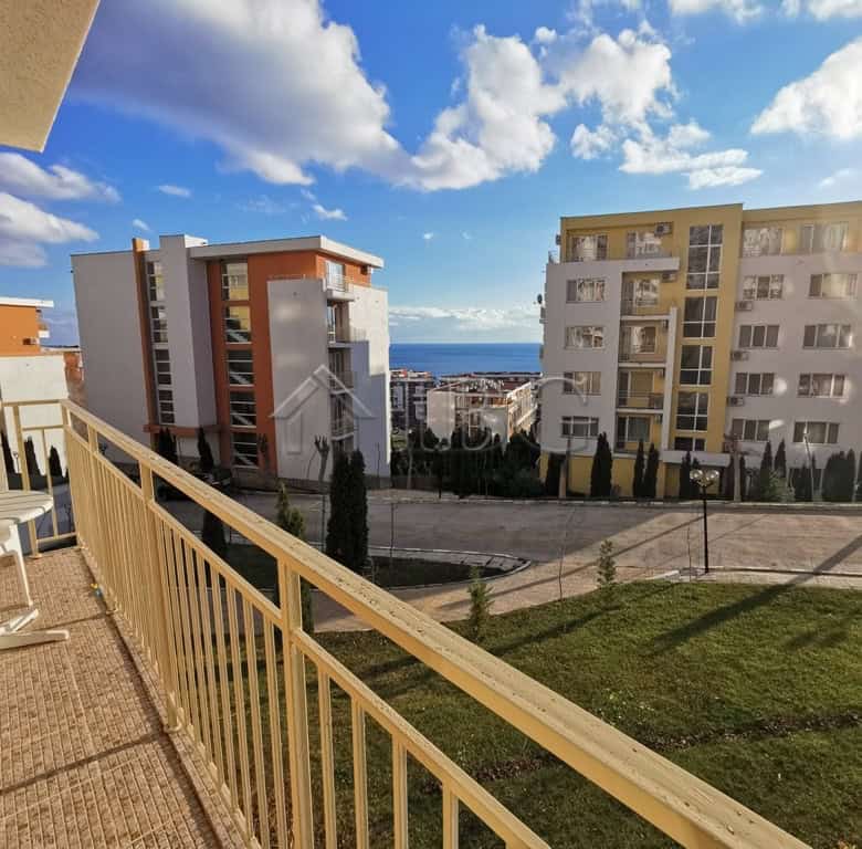 Bright balcony view of Sveti Vlas with modern apartment buildings and sea in the background.