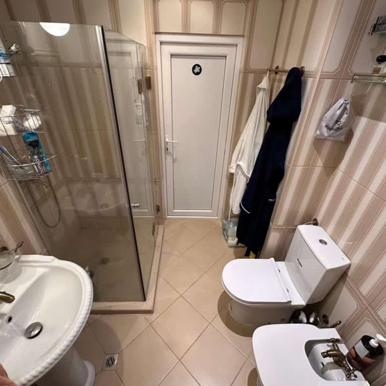 Bright bathroom with shower enclosure, modern fixtures, and ample storage in Venera Palace, Sunny Be.