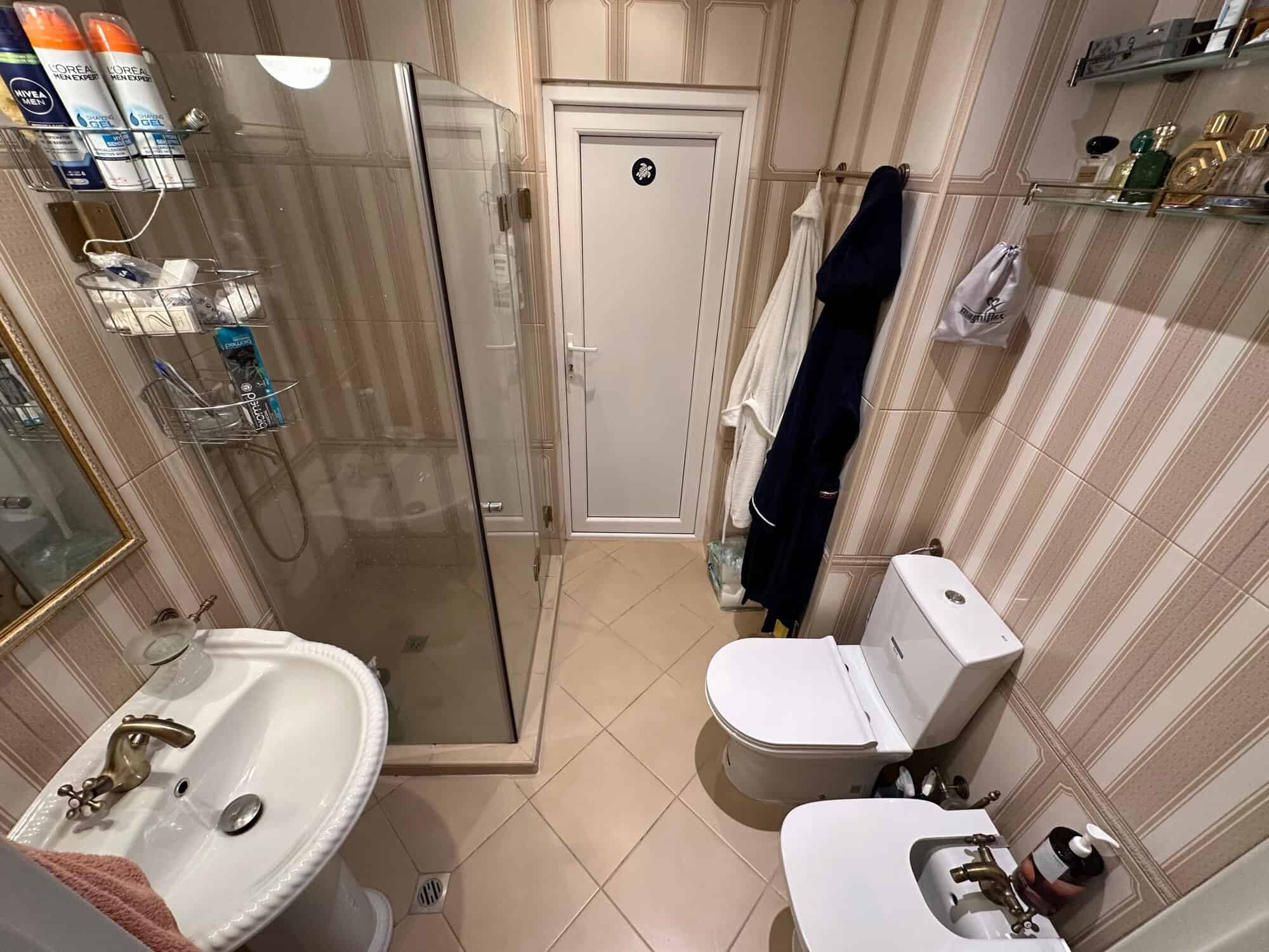Bright bathroom with shower enclosure, modern fixtures, and ample storage in Venera Palace, Sunny Be.