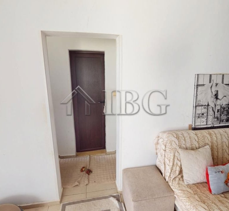Bright living room with comfortable sofa and decorative cushions in Kosharitsa.