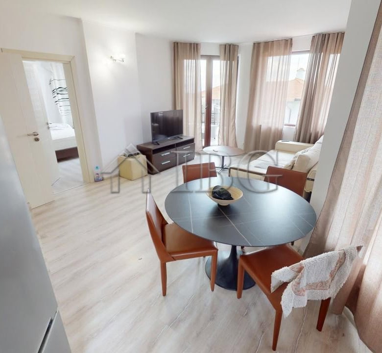 Bright living room with dining area and large windows in Kosharitsa apartment.