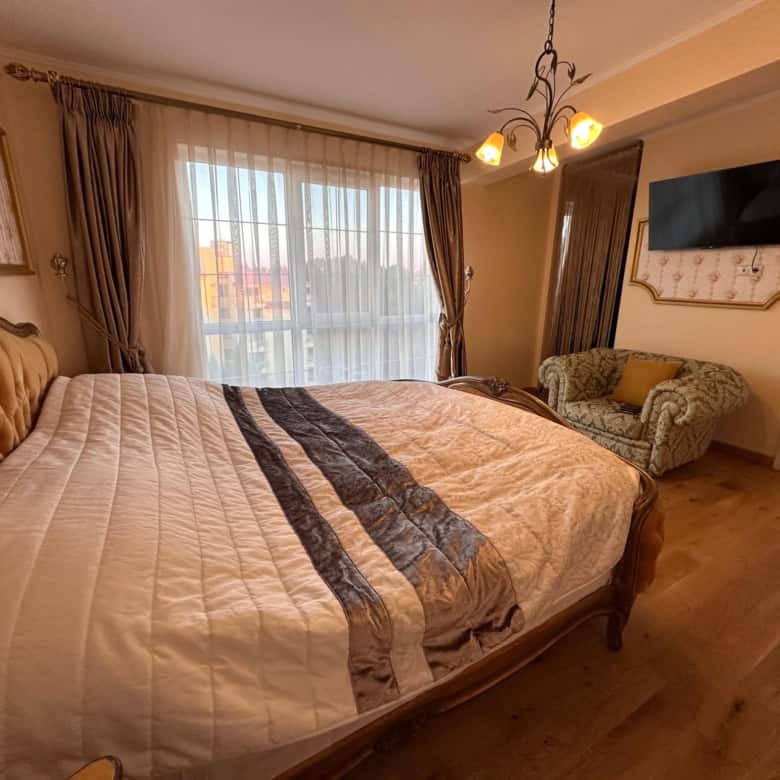 Interior view of a spacious 2-bedroom apartment in Venera Palace, Sunny Beach, with a large bed and.