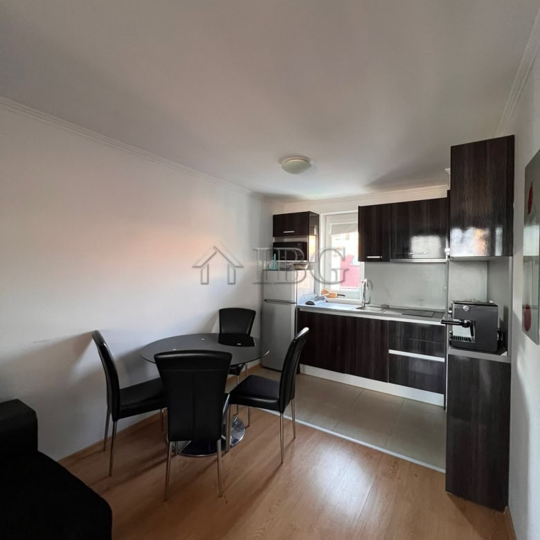 Modern kitchen and dining space in a one-bedroom apartment with sea views.