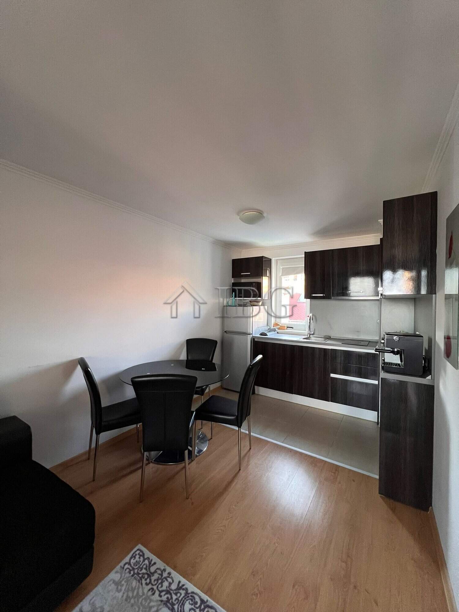 Modern kitchen and dining space in a one-bedroom apartment with sea views.