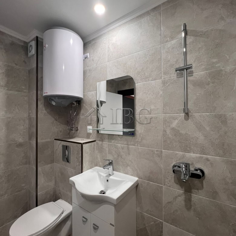 Bathroom with toilet, sink, and water heater in Sveti Vlas.
