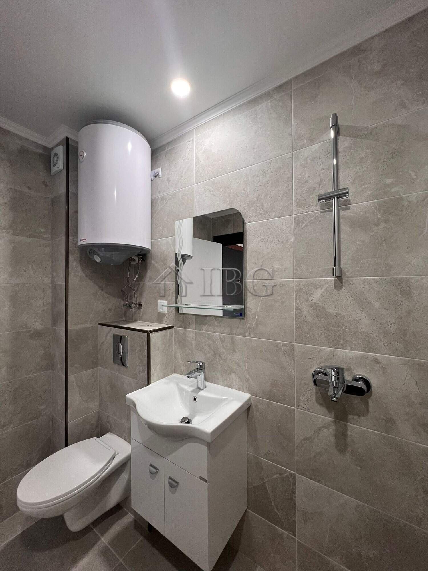 Bathroom with toilet, sink, and water heater in Sveti Vlas.