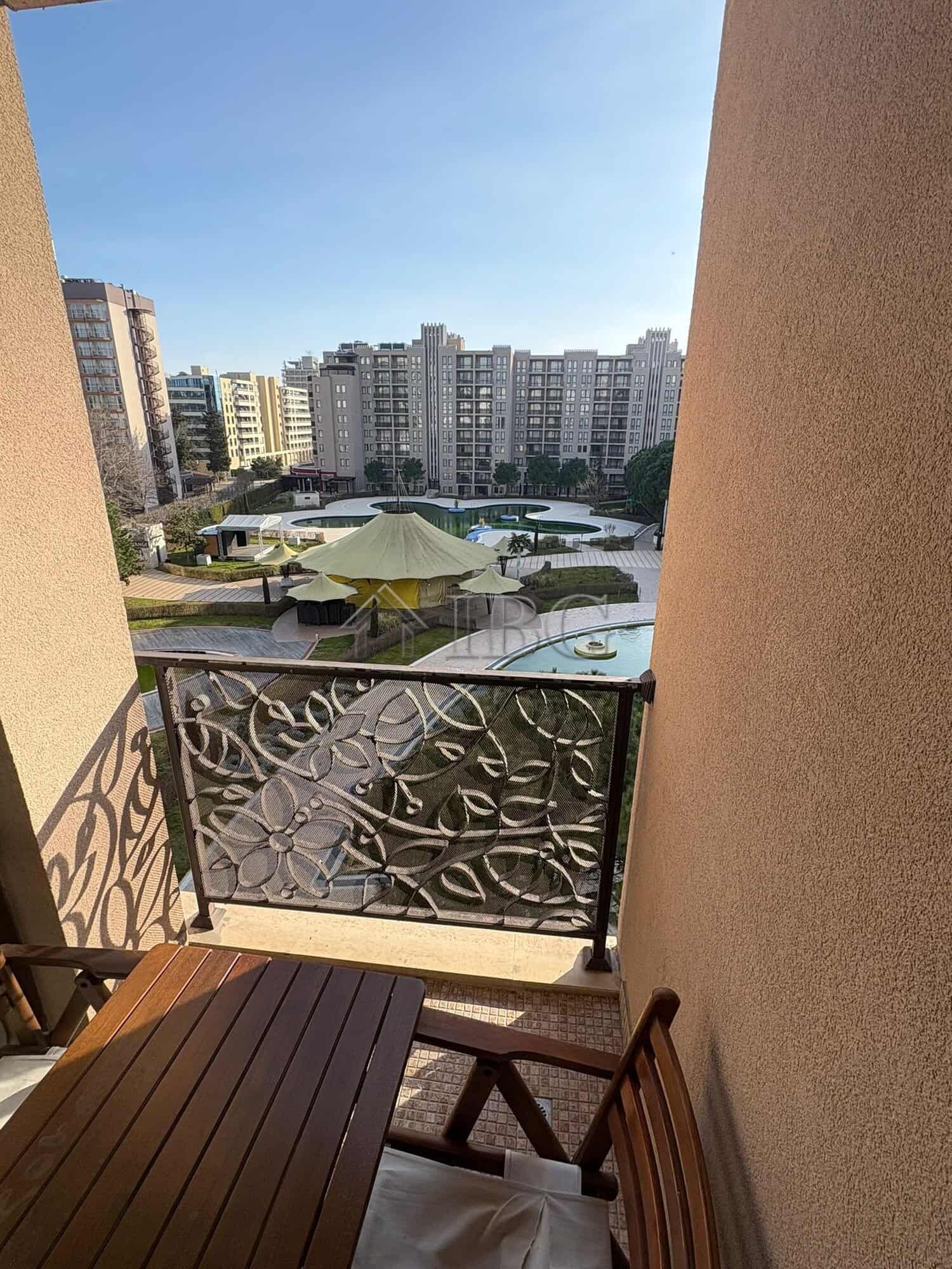 Spacious Studio with Pool View Balcony view of pool and city skyline from a studio apartment.