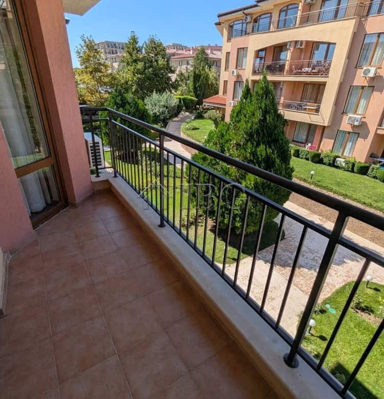 Balcony view of lush garden and neighboring apartment buildings in Sveti Vlas.