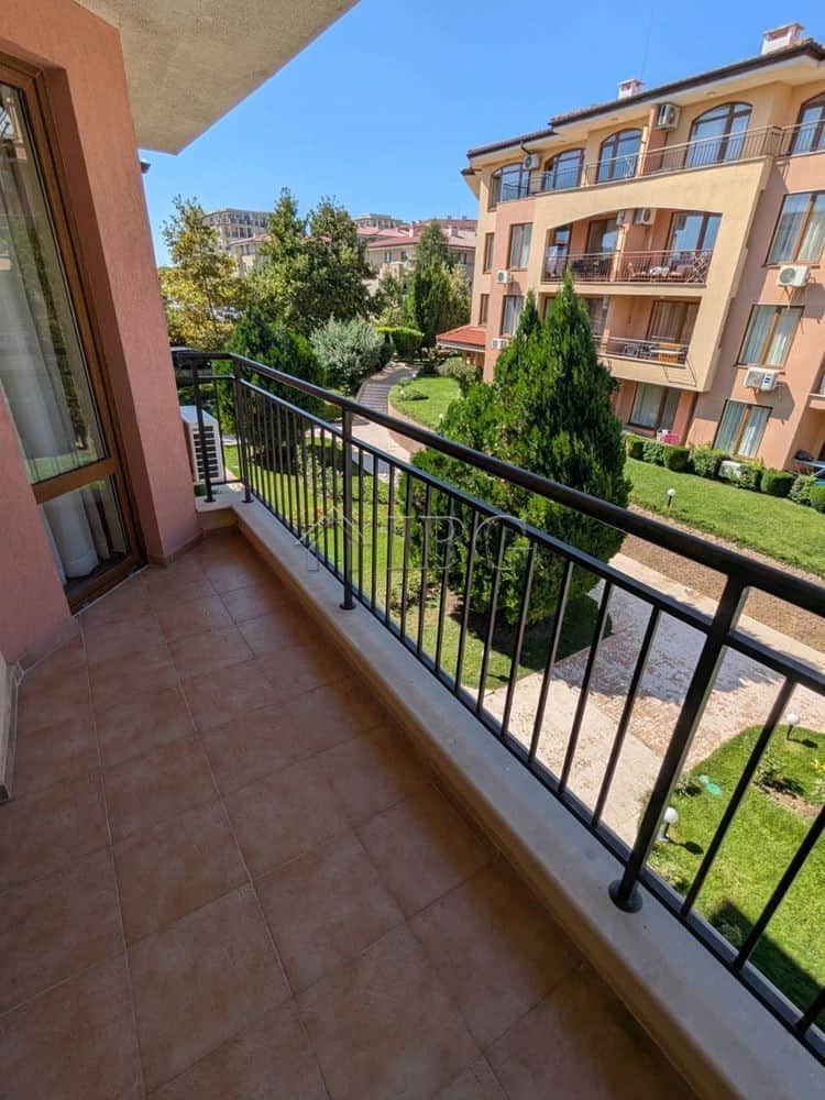 Balcony view of lush garden and neighboring apartment buildings in Sveti Vlas.