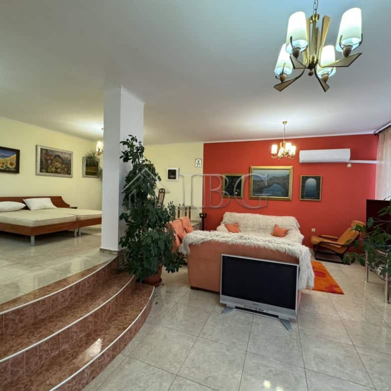 Elegant living room with modern decor and ample natural light in Kosharitsa property.