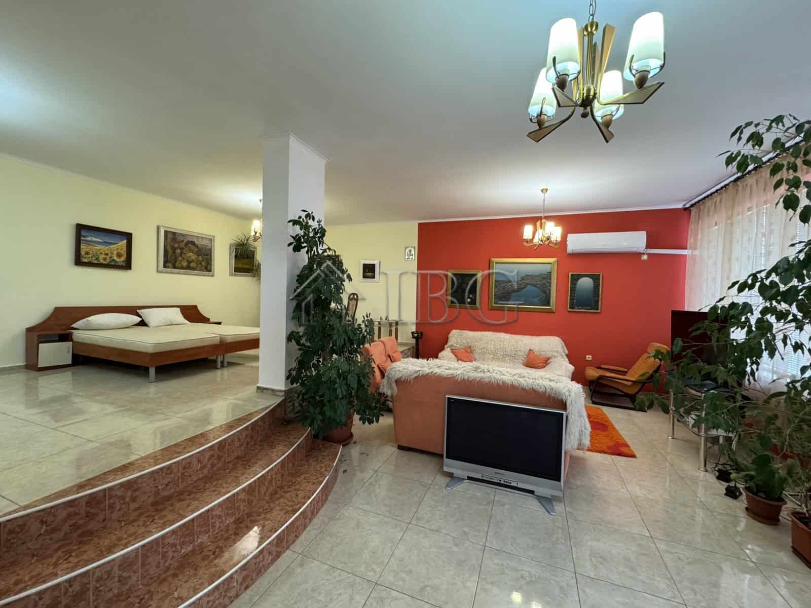 Elegant living room with modern decor and ample natural light in Kosharitsa property.