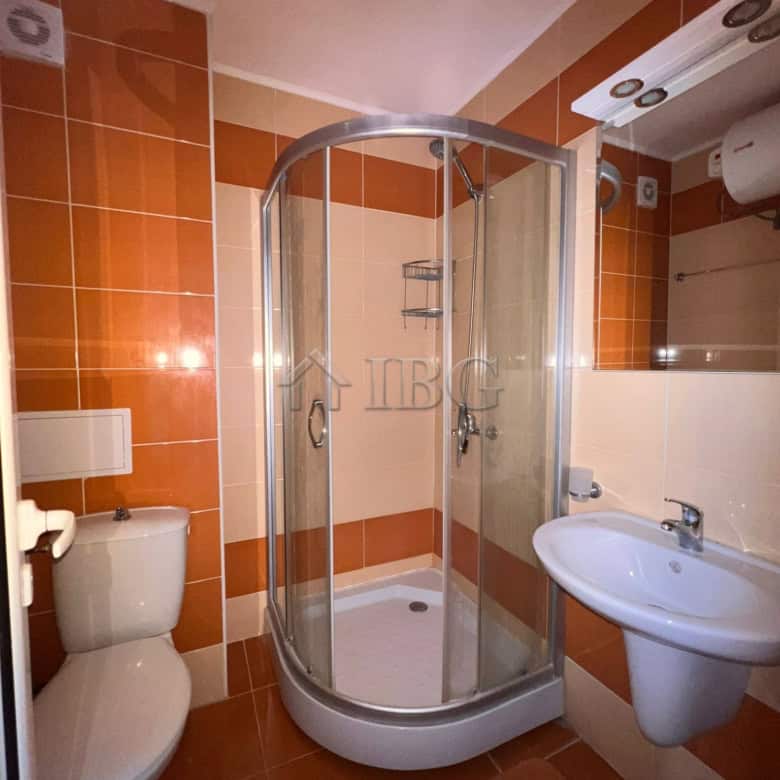 Bathroom with shower cabin, toilet, and sink in Sveti Vlas apartment.