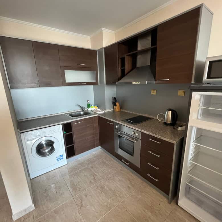 Modern kitchen with appliances and partial sea view in Sveti Vlas apartment.