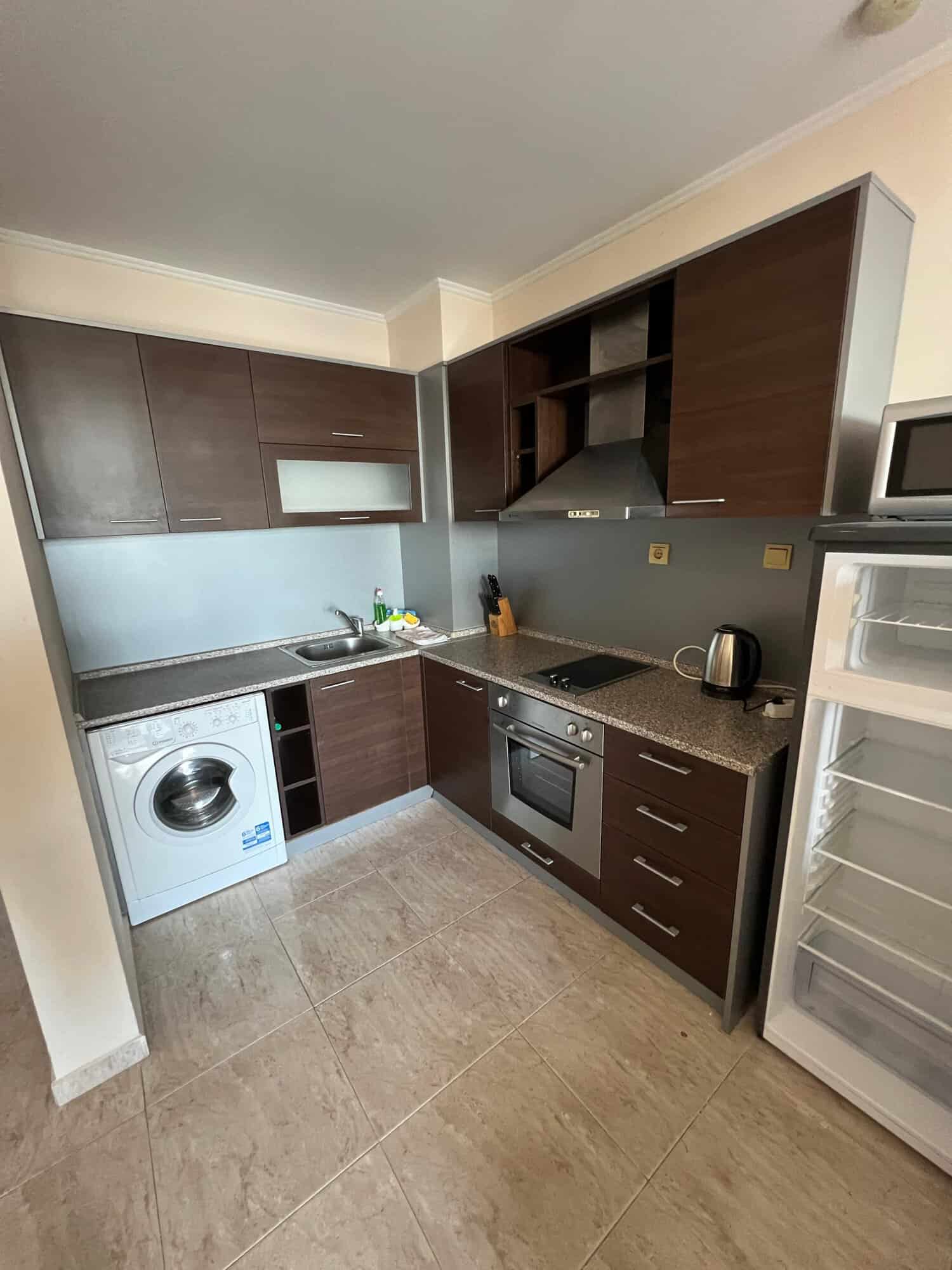 Modern kitchen with appliances and partial sea view in Sveti Vlas apartment.
