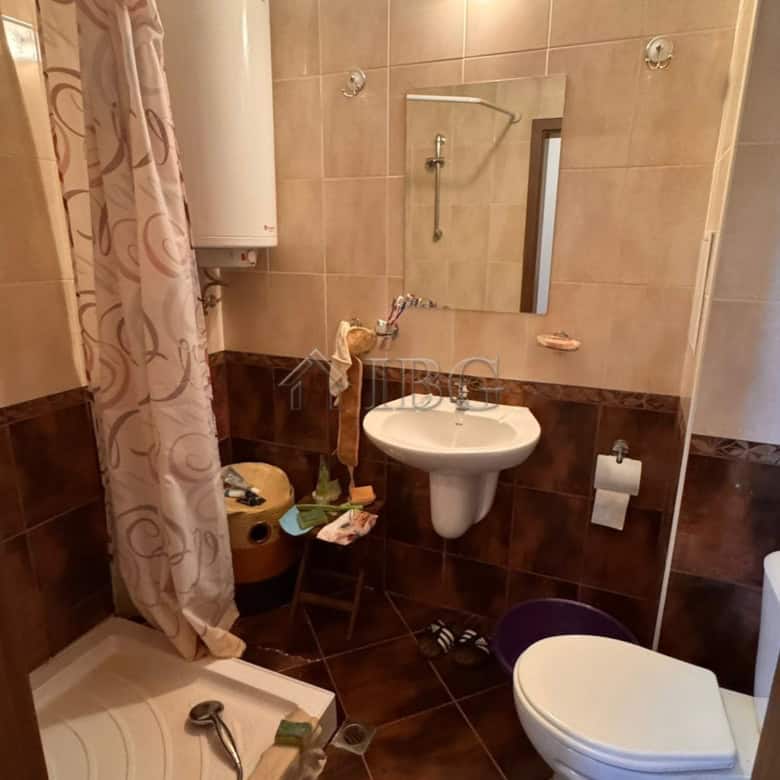 Bathroom with shower, sink, and toilet in Sveti Vlas apartment.