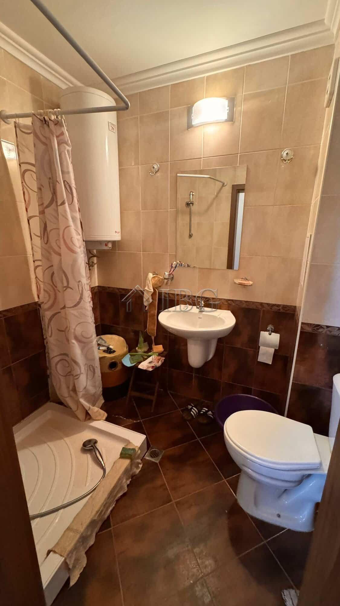 Bathroom with shower, sink, and toilet in Sveti Vlas apartment.