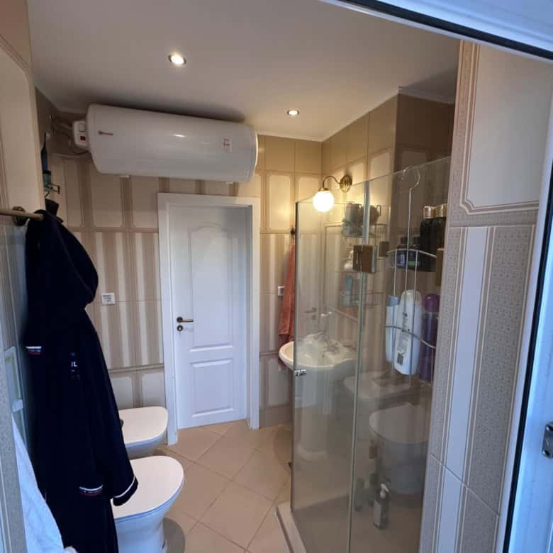 Bathroom with shower, washing machine, and air conditioning in Venera Palace, Sunny Beach.