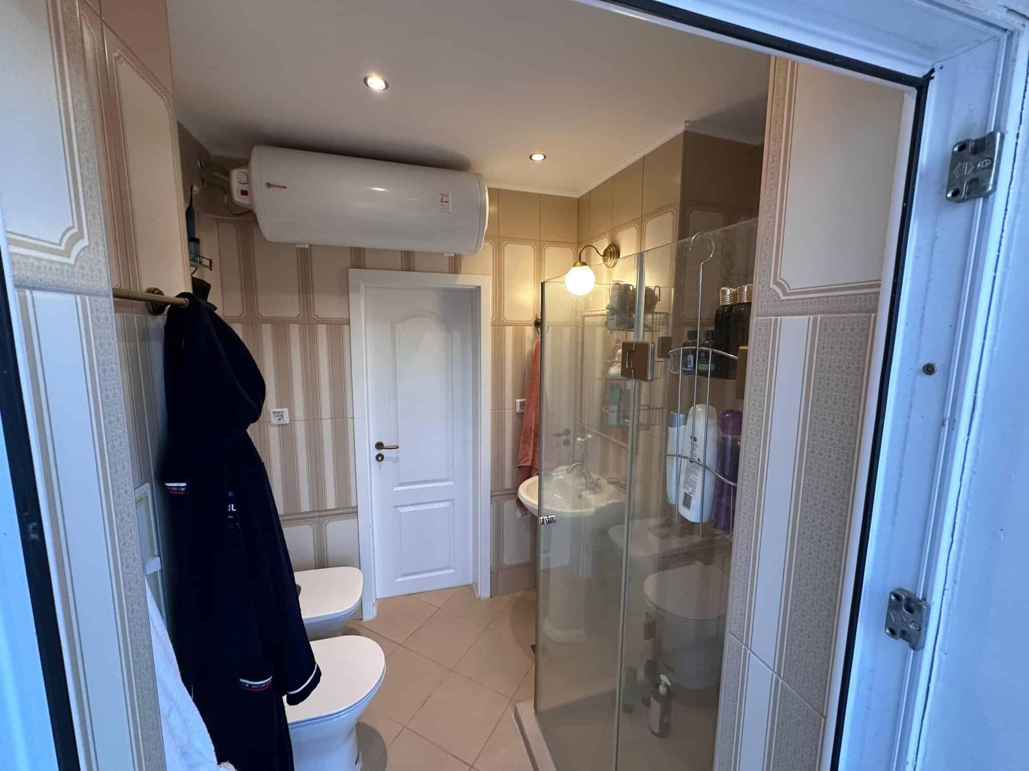 Bathroom with shower, washing machine, and air conditioning in Venera Palace, Sunny Beach.