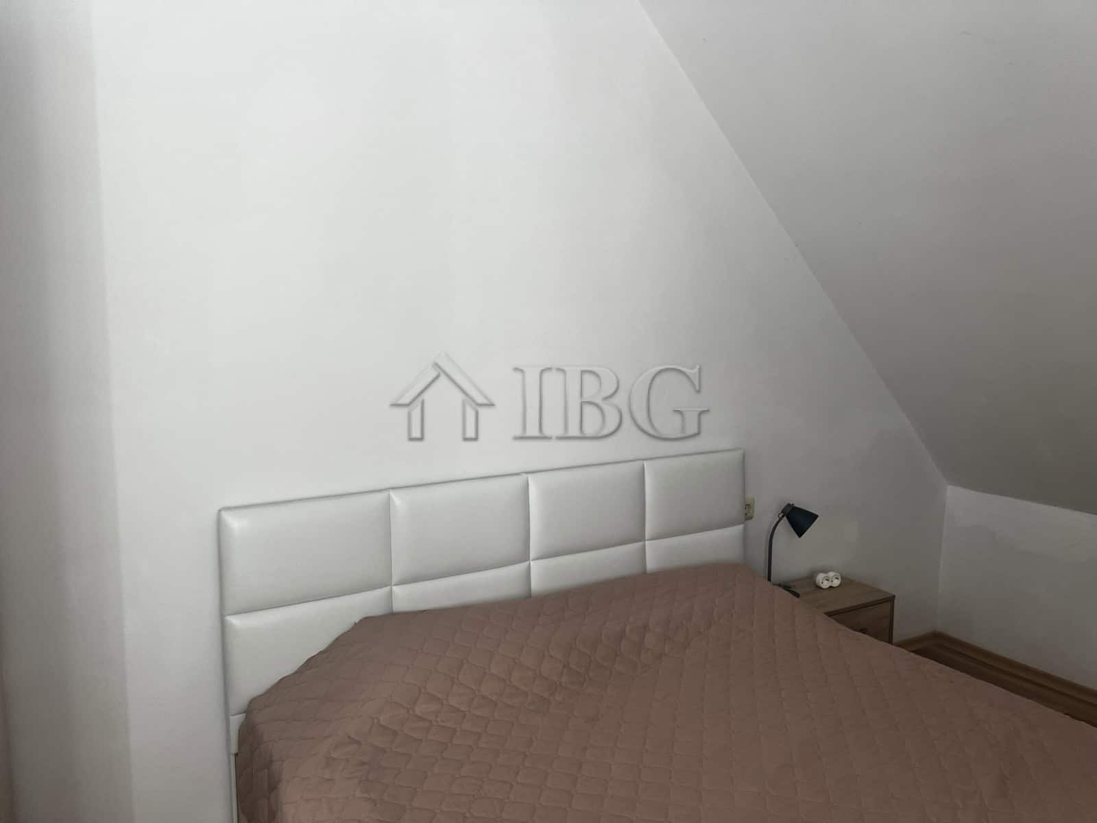 Modern bedroom with white headboard and sea view in Ravda apartment.