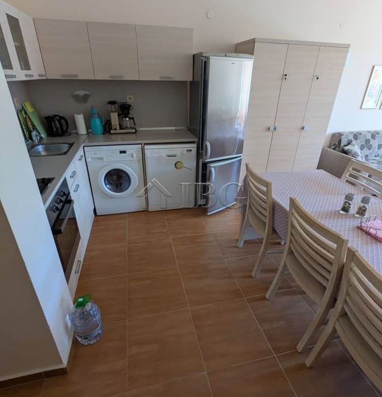 Bright kitchen and dining area with modern appliances and pool view.