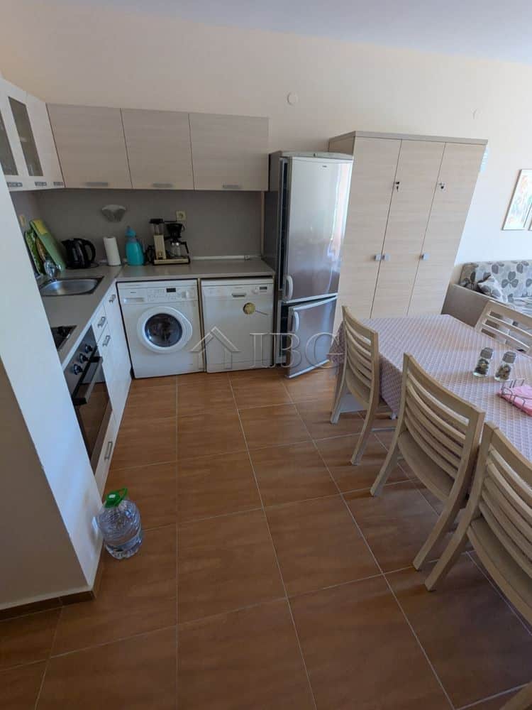 Bright kitchen and dining area with modern appliances and pool view.
