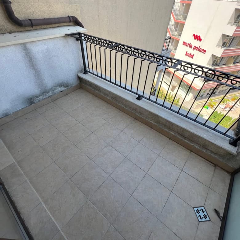 Balcony overlooking Sunny Beach cityscape with railing and tiled floor, perfect for relaxing and enj.