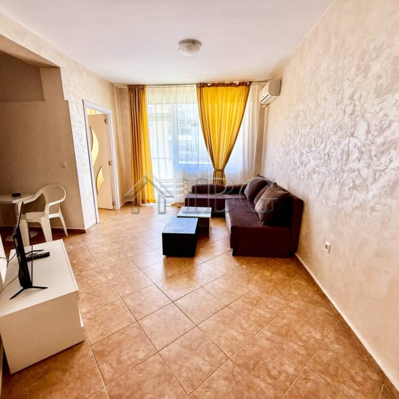 Bright living room with south-facing windows and yellow curtains.