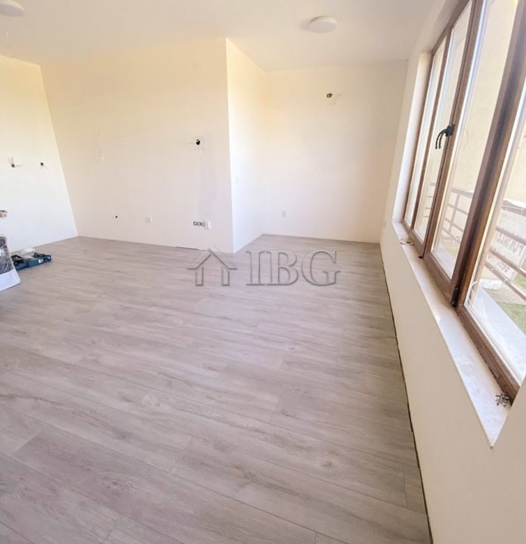 Bright interior of a 1-bedroom apartment with large windows and light wood flooring at Lighthouse Go.