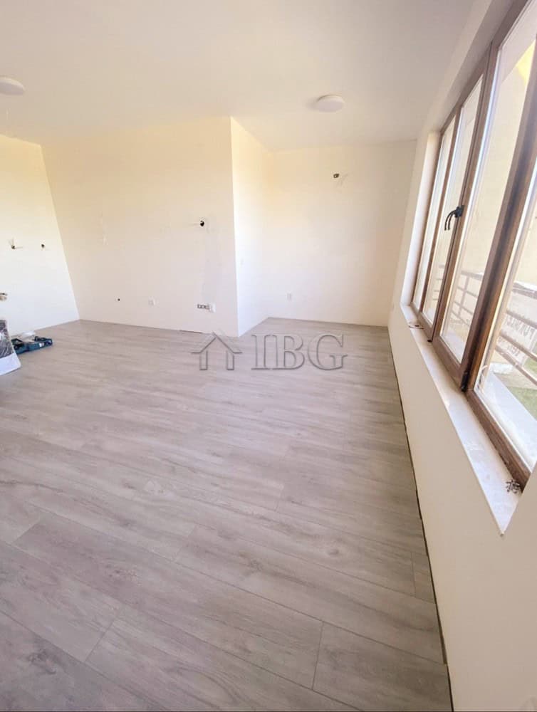 Bright interior of a 1-bedroom apartment with large windows and light wood flooring at Lighthouse Go.