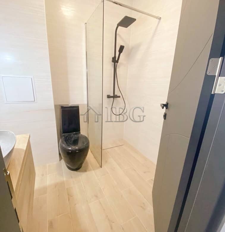 Furnished 1-bedroom apartment bathroom with walk-in shower in Lighthouse Golf & Spa Resort.