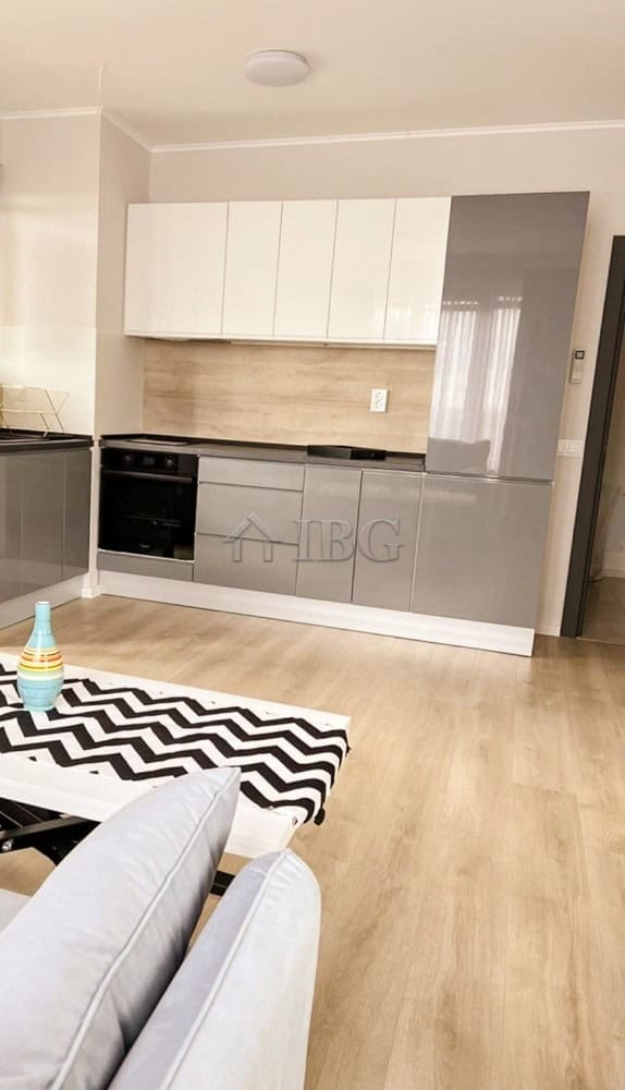 Fully furnished 1-bedroom apartment kitchen with modern cabinets and appliances.