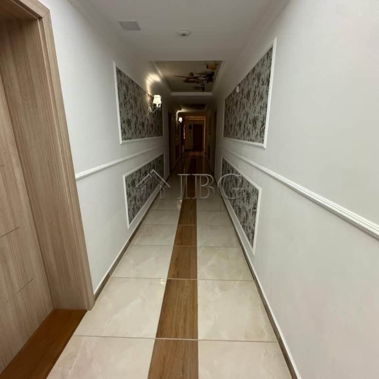 Bright, clean corridor with elegant wall decor and wooden accents.