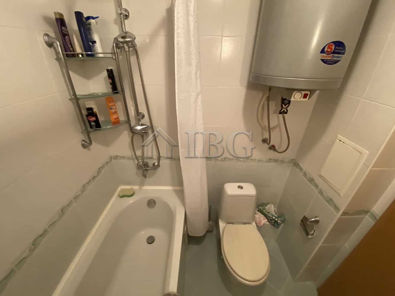 Apartment bathroom with bathtub, toilet, and water heater in Vineyards Resort, Aheloy.