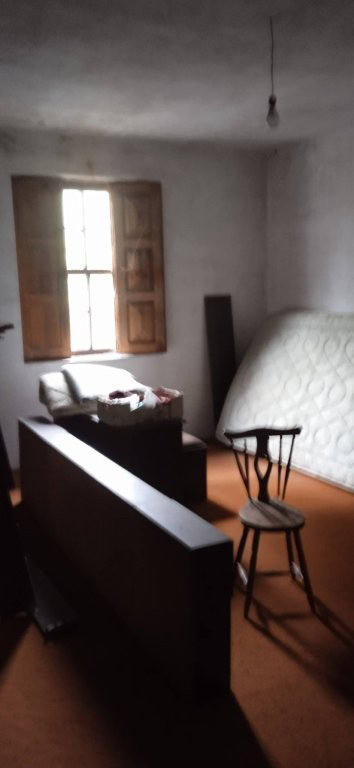 Interior view of a rustic farm estate in Santa Comba Dao, showcasing simple furnishings and natural.