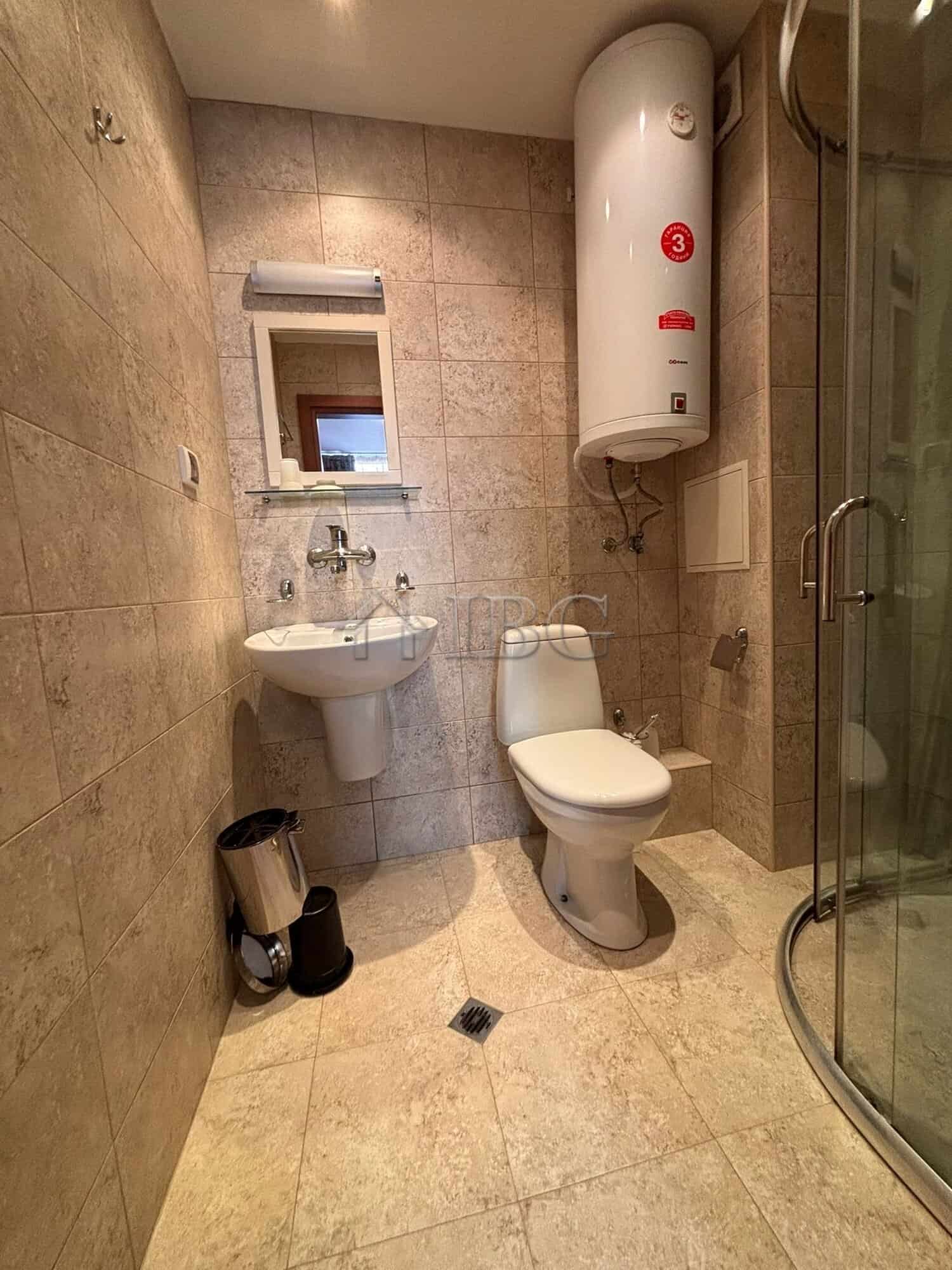 Modern bathroom with shower, toilet, and water heater in Dawn Park, Sunny Beach.