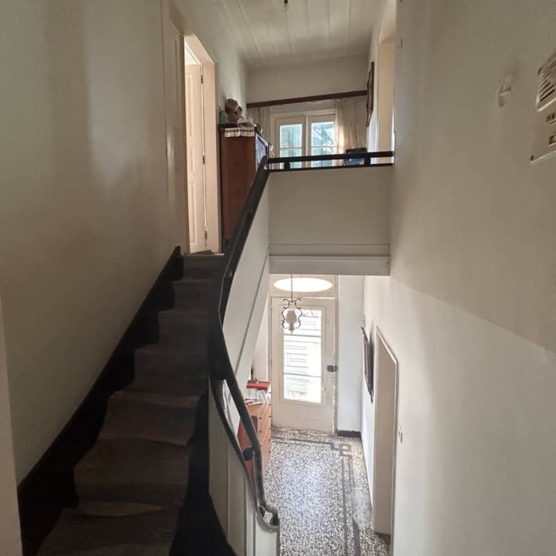 Interior view of a cozy multi-level home with staircase and hallway.