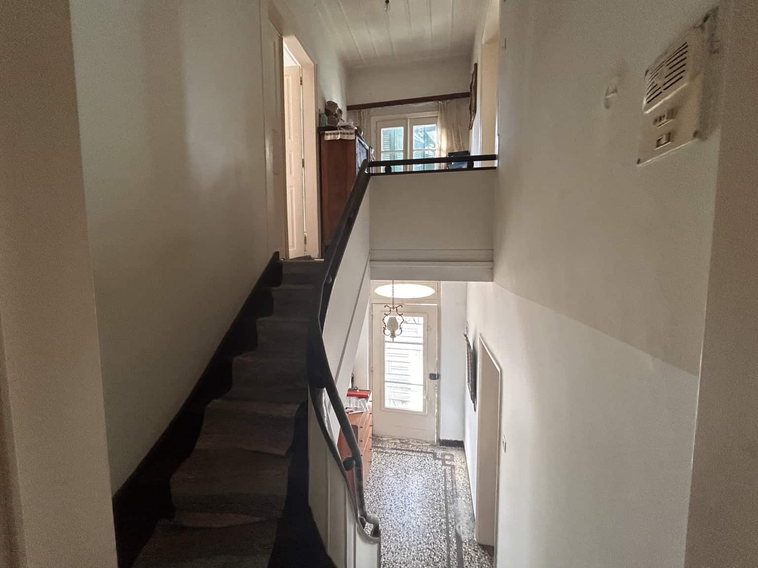Interior view of a cozy multi-level home with staircase and hallway.