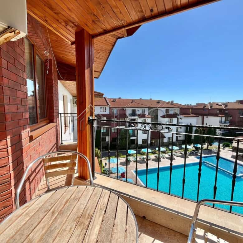 Bright balcony view of pool and neighborhood in Ravda. Perfect for relaxing or enjoying the sunny Bu.