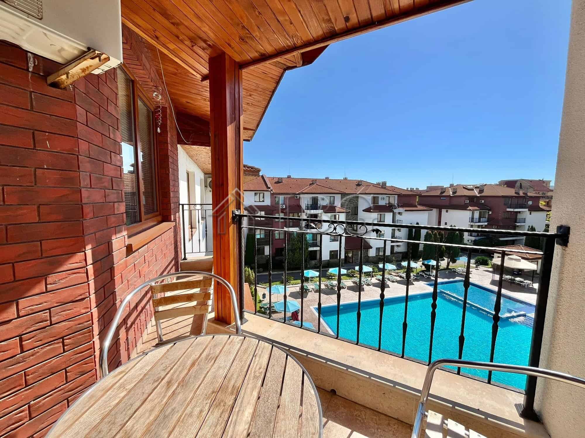 Bright balcony view of pool and neighborhood in Ravda. Perfect for relaxing or enjoying the sunny Bu.