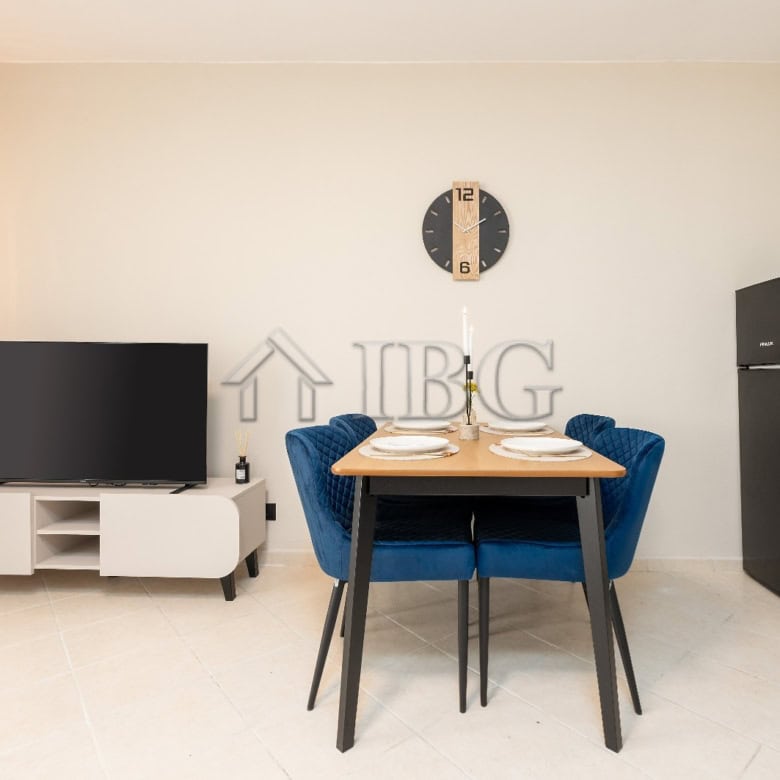 Bright interior of a renovated 2-bedroom apartment with modern furnishings and a view of the pool.