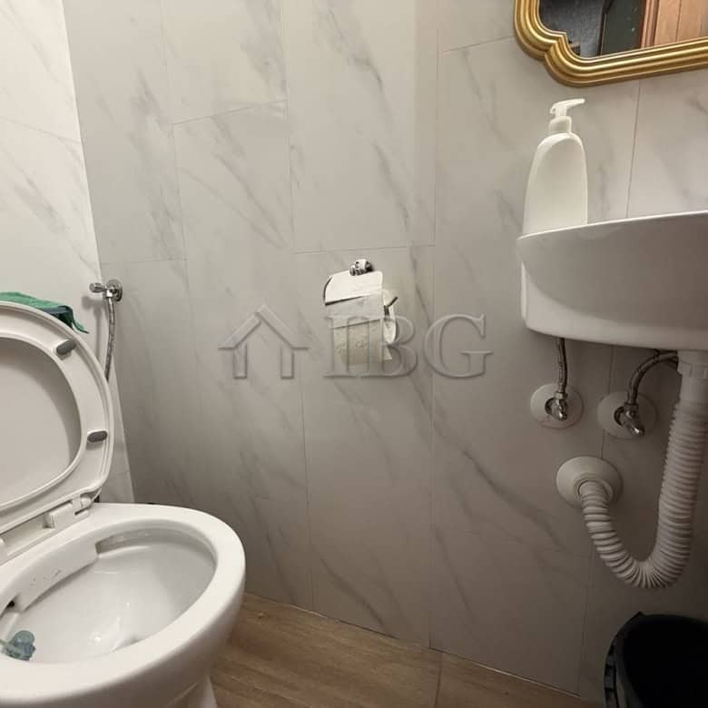 Modern bathroom with toilet and sink in a new apartment in Kosharitsa.