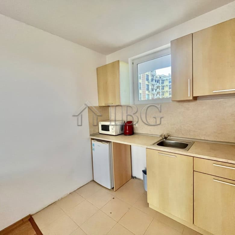 Bright kitchen with wooden cabinets and a small window in Sveti Nikola complex.