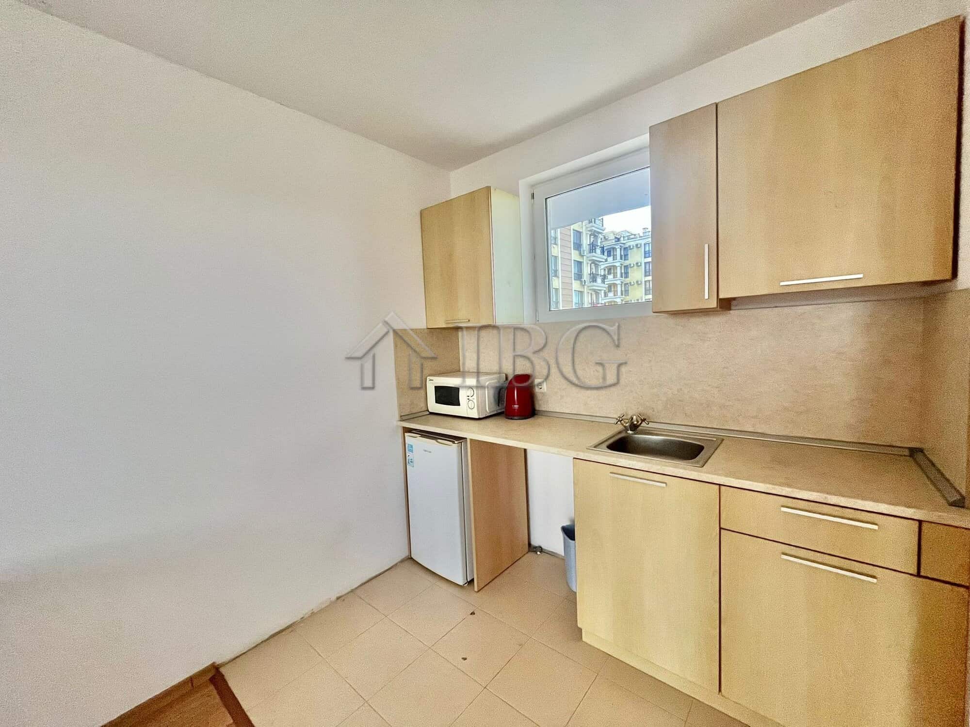 Bright kitchen with wooden cabinets and a small window in Sveti Nikola complex.